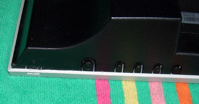 image of the plastic catch on the lower lefthand corner of the display when placed face down on a table